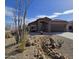 Single-story home features desert landscaping, covered entryway, and attached two car garage at 8965 E Red Mountain Ln, Gold Canyon, AZ 85118