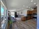 Open-concept living area with pool views, modern kitchen, and wood floors at 8965 E Red Mountain Ln, Gold Canyon, AZ 85118