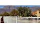 Scenic neighborhood view showing mature trees, desert landscaping, and a privacy fence at 8965 E Red Mountain Ln, Gold Canyon, AZ 85118