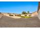 Spacious backyard featuring low-maintenance gravel landscaping and a patch of green turf at 9138 E Emerald Dr, Sun Lakes, AZ 85248