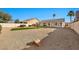 Large backyard with gravel and artificial turf, featuring a covered patio and privacy wall at 9138 E Emerald Dr, Sun Lakes, AZ 85248