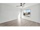 Bedroom with a ceiling fan, light hardwood floors, a large window, and white walls at 9138 E Emerald Dr, Sun Lakes, AZ 85248