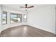 Empty room with light hardwood flooring, a bay window, and white walls, offering a bright and airy space at 9138 E Emerald Dr, Sun Lakes, AZ 85248