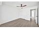 Bedroom with a ceiling fan, light hardwood floors, and a doorway leading to another room at 9138 E Emerald Dr, Sun Lakes, AZ 85248