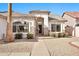 Inviting entryway with stone accents, decorative security door, and desert landscaping at 9138 E Emerald Dr, Sun Lakes, AZ 85248