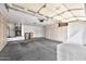 Well-organized garage featuring ample storage cabinets and clean concrete flooring at 9138 E Emerald Dr, Sun Lakes, AZ 85248