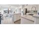 Well-lit kitchen showcasing quartz countertops, stainless steel appliances, and an open layout to the living area at 9138 E Emerald Dr, Sun Lakes, AZ 85248