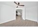 Open-concept living room with hardwood floors and a ceiling fan, leading to an open floor plan at 9138 E Emerald Dr, Sun Lakes, AZ 85248