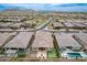 Stunning aerial view of a property with a backyard putting green, outdoor kitchen and swimming pool at 9302 W White Feather Ln, Peoria, AZ 85383