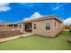 Inviting backyard featuring a putting green and patio with outdoor dining area at 9302 W White Feather Ln, Peoria, AZ 85383