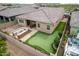 Enjoy this perfectly sized backyard with a built-in barbecue, outdoor dining area, and putting green at 9302 W White Feather Ln, Peoria, AZ 85383