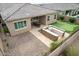 This cozy backyard features an outdoor kitchen with a stone grill and a covered dining area perfect for entertaining at 9302 W White Feather Ln, Peoria, AZ 85383