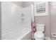 Bright bathroom with a white tiled shower-tub combo and matching toilet and vanity at 9302 W White Feather Ln, Peoria, AZ 85383