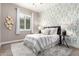 Charming bedroom featuring patterned wallpaper, a queen-sized bed and an area rug at 9302 W White Feather Ln, Peoria, AZ 85383