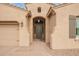 Welcoming front entrance featuring a covered porch and desert landscaping at 9302 W White Feather Ln, Peoria, AZ 85383