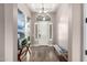 Elegant foyer with tile flooring, a stylish chandelier, and a welcoming bench at 9302 W White Feather Ln, Peoria, AZ 85383