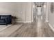 Inviting hallway features elegant flooring, neutral walls, and views of the entryway with a white door at 9302 W White Feather Ln, Peoria, AZ 85383