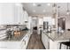 Spacious kitchen with white cabinets, stainless steel appliances, granite countertops, and tile backsplash at 9302 W White Feather Ln, Peoria, AZ 85383