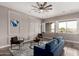 Stylish living room with natural light, modern decor, and inviting seating arrangement at 9302 W White Feather Ln, Peoria, AZ 85383