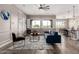 Bright living room with large windows, comfortable seating, and a cohesive, modern design at 9302 W White Feather Ln, Peoria, AZ 85383