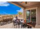 Stylish outdoor dining area with a modern table, chairs, and stunning water feature for entertaining at 9302 W White Feather Ln, Peoria, AZ 85383