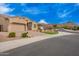 Picturesque street view featuring well-maintained homes and desert landscaping in a peaceful neighborhood setting at 9302 W White Feather Ln, Peoria, AZ 85383