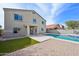 Exterior of home overlooking the backyard featuring a beautiful pool, grass and patio at 9574 W Quail Ave, Peoria, AZ 85382