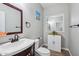 Well-lit bathroom with a decorative mirror, vanity, and sink with cabinet at 9574 W Quail Ave, Peoria, AZ 85382