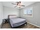 Relaxing bedroom features a fan, wood floors, and shutters for natural light at 9574 W Quail Ave, Peoria, AZ 85382