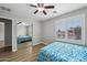 Bedroom features mirrored closet doors, wood-look floors, neutral paint, and natural light at 9574 W Quail Ave, Peoria, AZ 85382