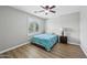 Bedroom with wood-look flooring, natural light, neutral walls, and a ceiling fan at 9574 W Quail Ave, Peoria, AZ 85382