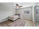 Well-lit bedroom with ceiling fan, hardwood floor, and closet with mirrored doors at 9574 W Quail Ave, Peoria, AZ 85382