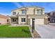 Traditional two-story home with a two-car garage, green landscaping, and a large concrete driveway at 9574 W Quail Ave, Peoria, AZ 85382