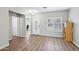 Inviting foyer with wood-look floors, a white front door, and a view into the adjacent office and living spaces at 9574 W Quail Ave, Peoria, AZ 85382