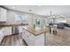 Well-lit kitchen featuring stainless steel appliances, a large island with granite countertops, and ample cabinet space at 9574 W Quail Ave, Peoria, AZ 85382