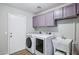 Modern laundry room with washer, dryer, sink, cabinets, and easy access to outside at 9574 W Quail Ave, Peoria, AZ 85382