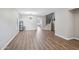 Spacious living room featuring wood-look flooring, a modern chandelier, and stairs to the second level at 9574 W Quail Ave, Peoria, AZ 85382