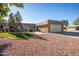 Charming single-story home featuring desert landscaping and an attached two-car garage at 9813 W Sandstone Dr, Sun City, AZ 85351