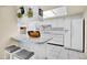 Bright kitchen with white appliances and tiled countertops at 9813 W Sandstone Dr, Sun City, AZ 85351