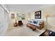 Bright living room area with a ceiling fan, carpet, and a sofa at 9813 W Sandstone Dr, Sun City, AZ 85351