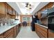 Well-equipped kitchen features dark wood cabinets, modern appliances, and an adjacent dining area at 10307 W Desert Rock Dr, Sun City, AZ 85351