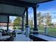 Spacious outdoor patio with comfortable seating, bar area, and view of backyard with golf course at 11945 N 83Rd Pl, Scottsdale, AZ 85260