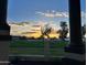 Scenic sunset view over the golf course, as seen from a covered porch, highlighting the community's peaceful setting at 11945 N 83Rd Pl, Scottsdale, AZ 85260