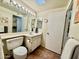 Bright bathroom features a vanity with a sink, a mirror with vanity lighting, and tile flooring at 12702 W Ashwood Dr, Sun City West, AZ 85375