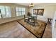 Charming dining room with a glass table set for four near large windows at 12702 W Ashwood Dr, Sun City West, AZ 85375