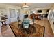 Open dining area featuring a glass-top table with seating for four and views into living room at 12702 W Ashwood Dr, Sun City West, AZ 85375