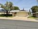 Charming single-story home featuring a well-manicured lawn and an inviting two-car garage at 12702 W Ashwood Dr, Sun City West, AZ 85375
