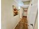Hallway featuring tile floors, artwork, and access to multiple rooms at 12702 W Ashwood Dr, Sun City West, AZ 85375