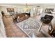 Open-concept living area with a comfortable couch, armchairs, and an ornate patterned rug at 12702 W Ashwood Dr, Sun City West, AZ 85375