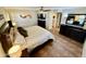 Bedroom with neutral walls, tile floor, a ceiling fan, and a view into the walk-in closet at 12702 W Ashwood Dr, Sun City West, AZ 85375